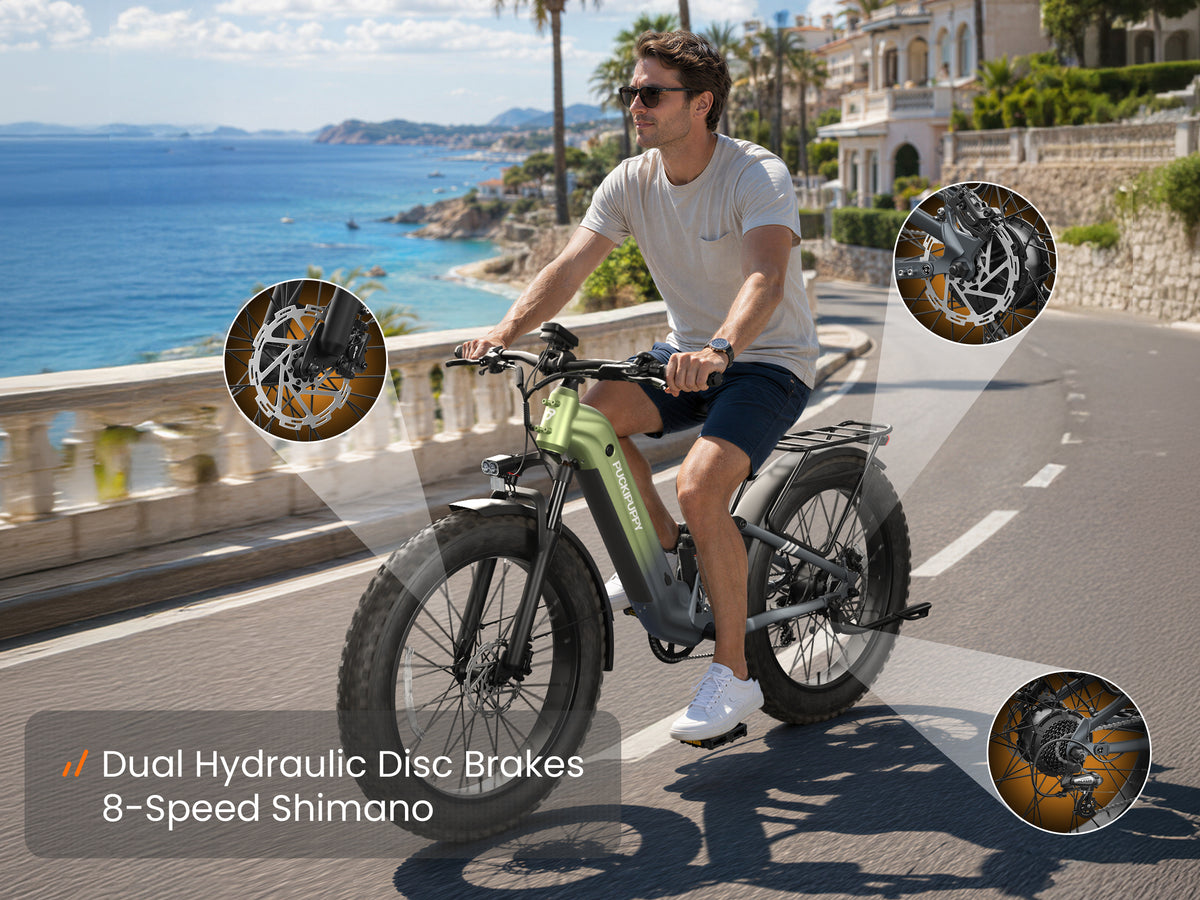 Rider on a green electric mountain bike with dual hydraulic disc brakes and 8-speed Shimano gearing.
