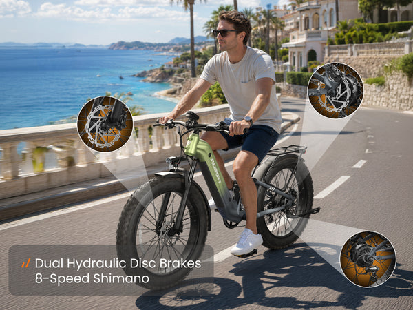Rider on a green electric mountain bike with dual hydraulic disc brakes and 8-speed Shimano gearing.