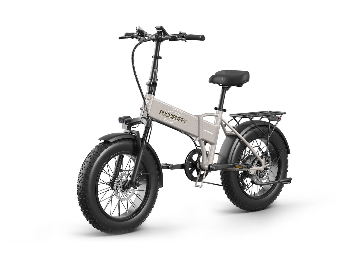 PUCKIPUPPY Dachshund folding electric bike with fat tires, rear cargo rack, full fenders, front suspension, and integrated headlight.