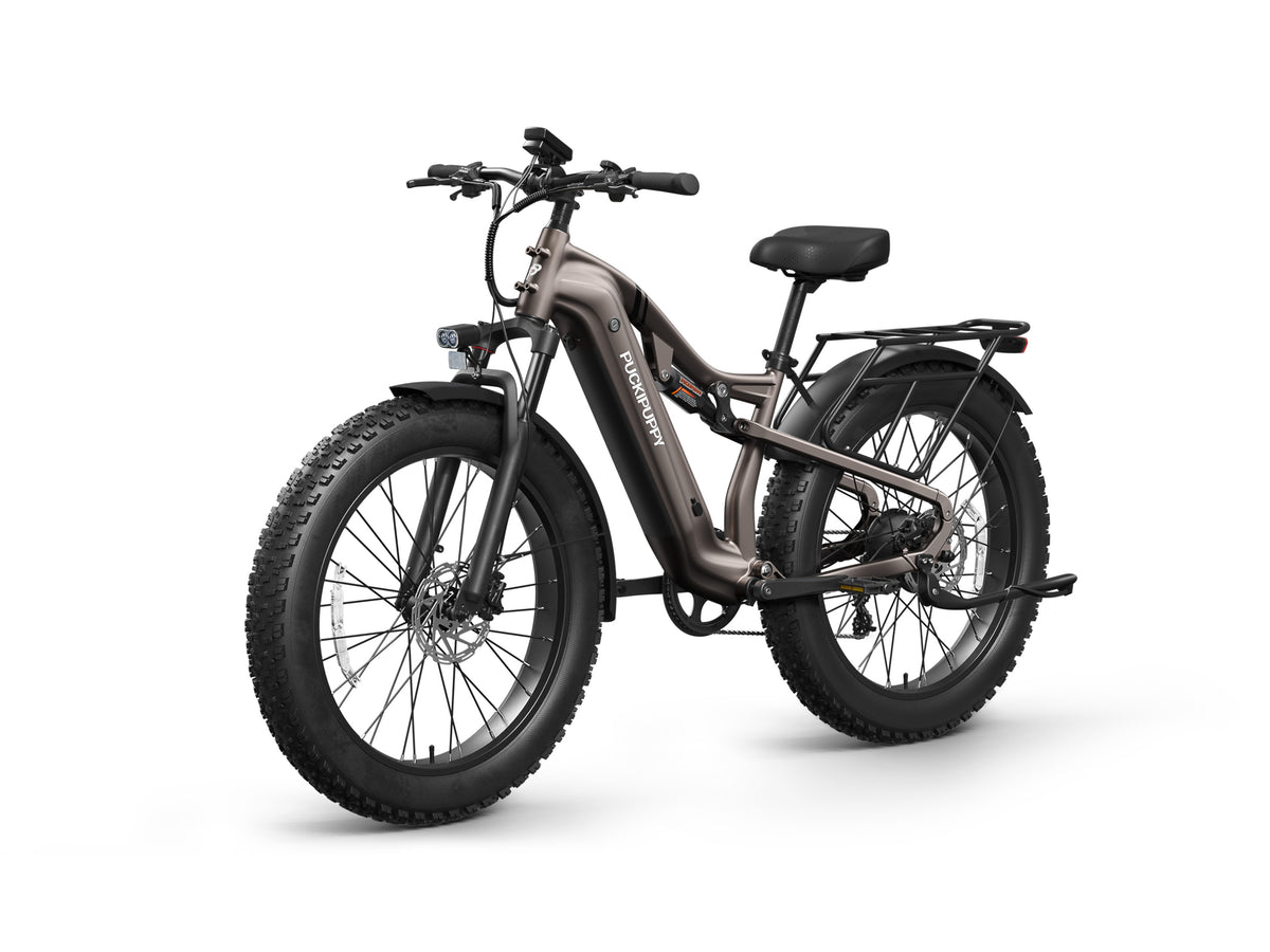 Bronze PUCKIPUPPY Labrador Pro fat tire electric bike with full suspension, rear cargo rack, full fenders, and integrated front light.